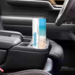 Tumbler in car cup holder with beach and water scene visible as well as custom added name.
